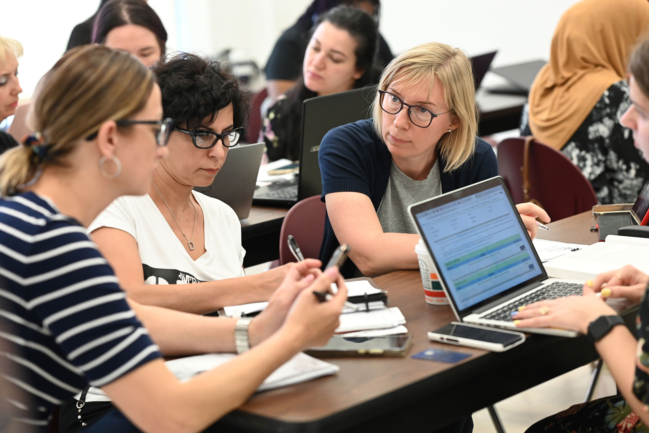 group of students in a classroom engaged in discussion