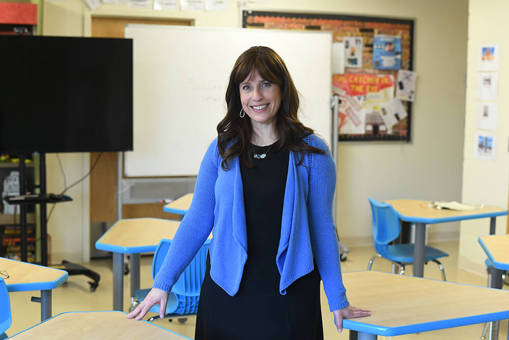 Freidi Hyman standing in her classroom