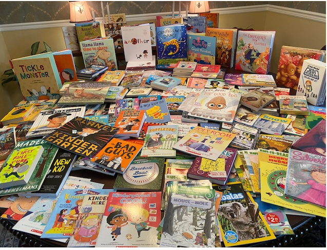 A table of books that were collected for donation in honor of World Book Day.